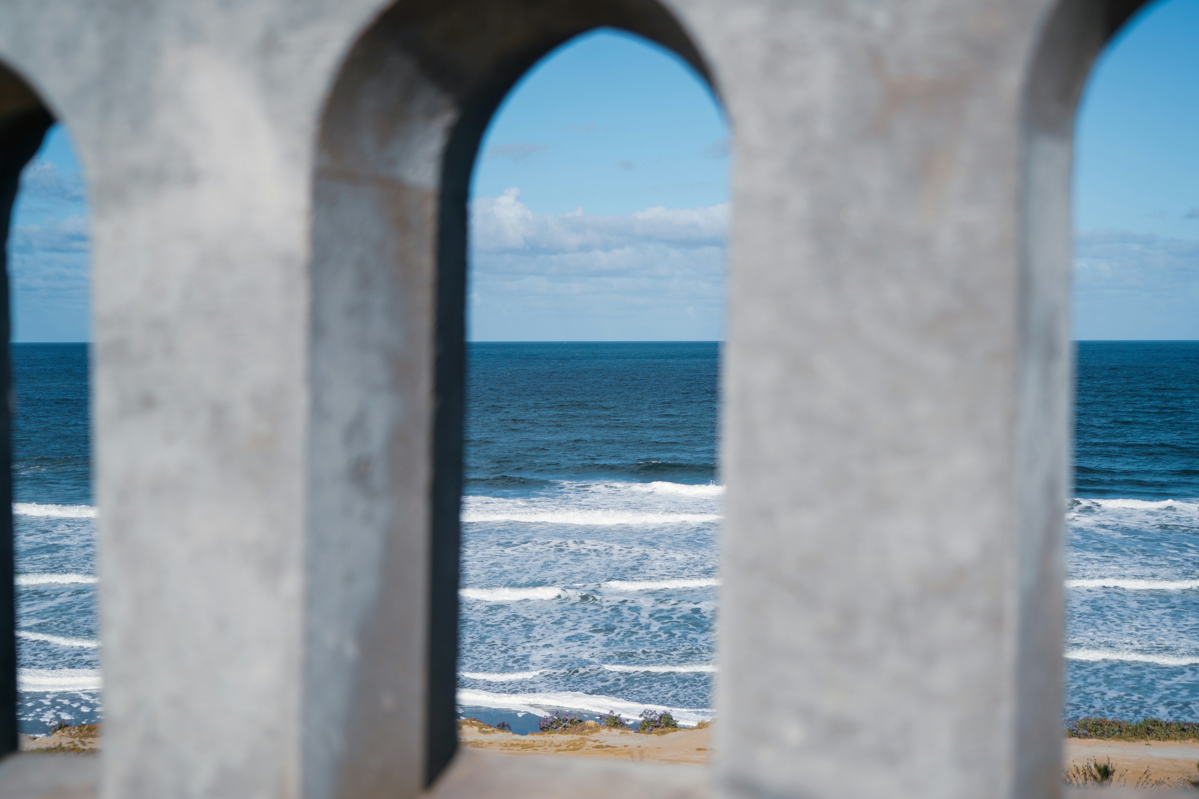 white concrete building near sea during daytime